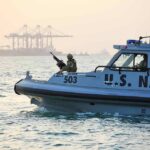Lethal Strikes Replace Coast Guard Playbook U.S. Navy patrol boat with armed crew on the water