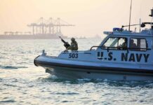 U.S. Navy patrol boat with armed crew on the water