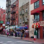 Map Snub Explodes: Little Italy Missing City street with brick buildings, fire escapes, and busy storefronts