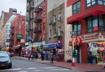 Map Snub Explodes: Little Italy Missing City street with brick buildings, fire escapes, and busy storefronts