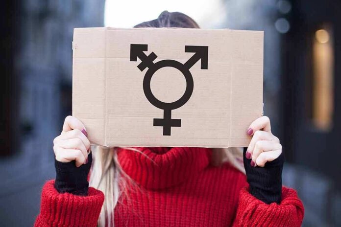 Person holding cardboard sign with gender symbol