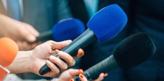 Reporters holding colorful microphones