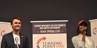 Curro Savoy at a TPUSA event with another speaker on stage