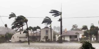 Houses battered by hurricane winds and flooding