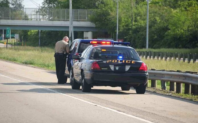 shutterstock_12763549-6 Police officer conducting a traffic stop on a highway