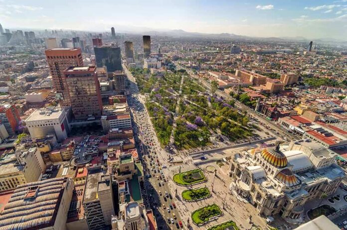Aerial view of a large city center with a domed palace and tree-lined boulevard