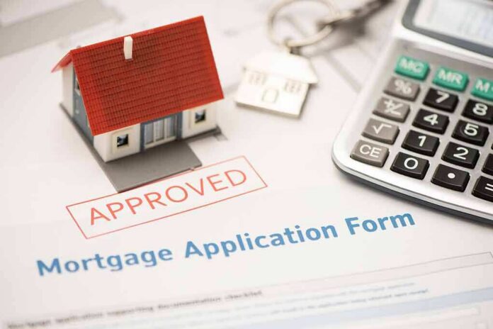 Mortgage application form with approved stamp, model house, and calculator