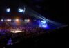 Wrestling ring in a packed arena with stage lights