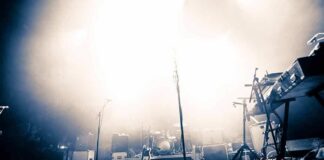 Empty concert stage with instruments and bright lights