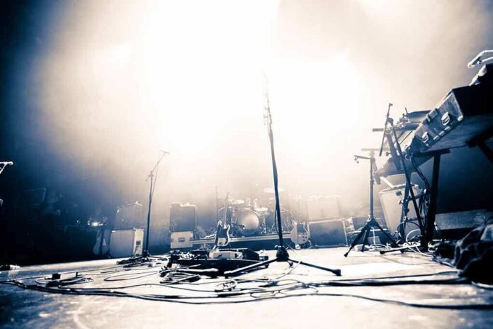 shutterstock_140154739-8 Empty concert stage with instruments and bright lights