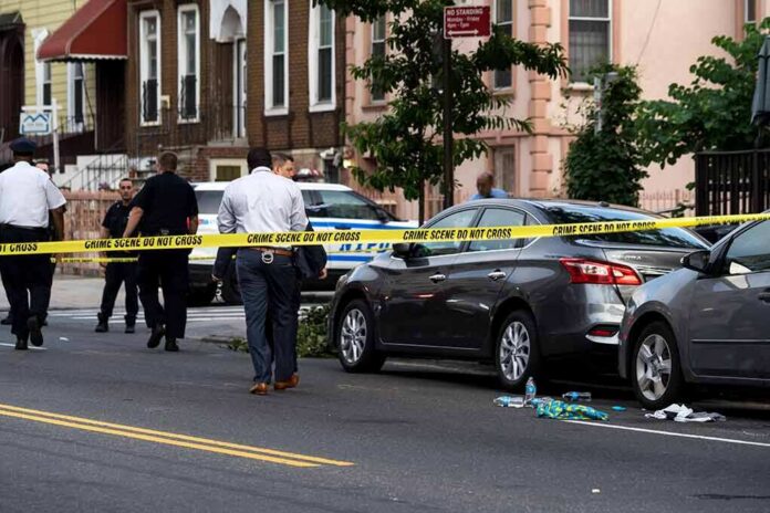 Police at urban street crime scene with yellow tape around parked cars
