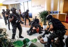 The SAS Operator Who Ran Toward Gunfire Tactical police detain suspects in an office lobby