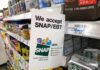 Shelf sign in a grocery aisle showing SNAP EBT acceptance