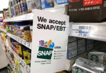 USDA Targets 170 Stores in SNAP Crackdown Shelf sign in a grocery aisle showing SNAP EBT acceptance