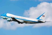 Air Force One aircraft ascending against a blue sky