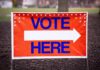 Hypocrisy Alert: Talarico’s Black‑And‑White Flip Vote here sign with right-pointing arrow outdoors