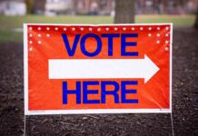 Hypocrisy Alert: Talarico’s Black‑And‑White Flip Vote here sign with right-pointing arrow outdoors