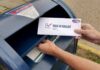 Another Mailman Arrested – What’s Going On?! Person mailing a ballot into a blue street mailbox