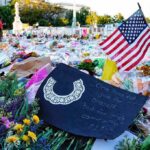 How Ground Zero Keeps 9/11 Memory Alive Memorial site with flowers and a U.S. flag