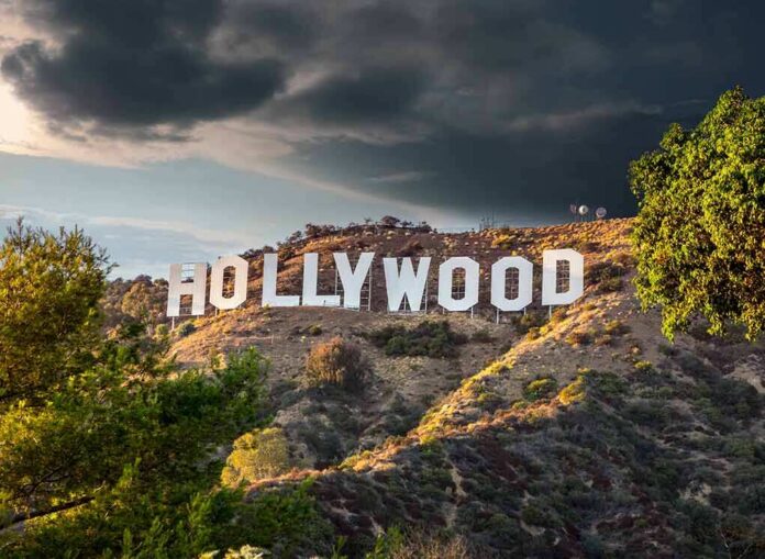 Hollywood sign on hillside under dramatic clouds