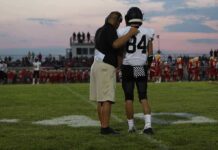 Nation-Leading Streak SHATTERED In 30 Seconds football coach with arm around player number 84 on sideline