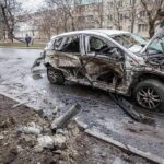 burned-out car with severe damage on a city street