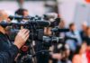 Royal Heir Enters Britain’s Power Factory Video cameras on tripods at a media event