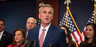 Kevin McCarthy speaks at a podium with Elise Stefanik, Tom Emmer, and Richard Hudson behind him