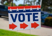 Election sign with the word VOTE and red arrows