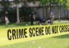 crime scene tape cordoning off a grassy area