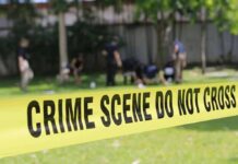 Park Soccer Match Ends With Slashing crime scene tape cordoning off a grassy area