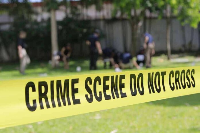 shutterstock_308657879 crime scene tape cordoning off a grassy area