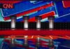 Debate stage with four podiums and colorful star backdrop