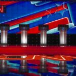 Debate stage with four podiums and colorful star backdrop