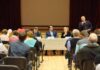 CMS Boss Lands Role at MAHA Summit Panel of speakers at a community meeting addressing an audience