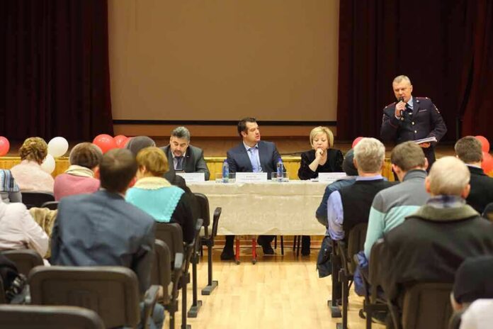 Panel of speakers at a community meeting addressing an audience