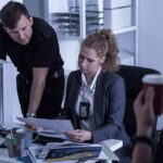 Independent Journalism Faces A Trust Problem Police officers reviewing documents at a desk