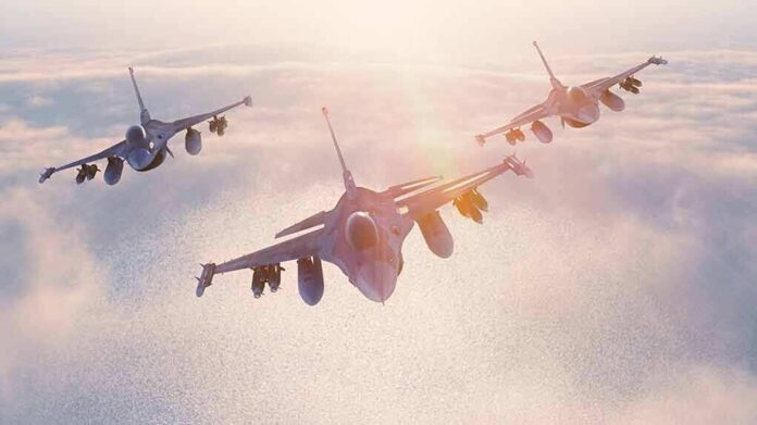 shutterstock_405633937-8 Three fighter jets flying in formation above clouds at sunrise