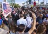 Vance Confronts Convention Protester In Dallas crowd of protesters and media at a street demonstration