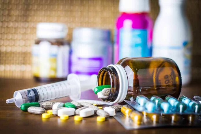 shutterstock_544348294-2 Medicine pills and syringe on table with brown bottle