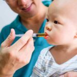 One Client, Multiple Babies, One Legal Battle Baby taking liquid medicine from an oral syringe held by an adult