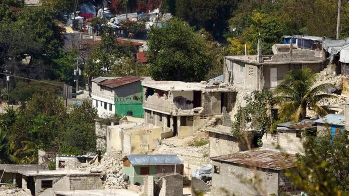 Hillside neighborhood with damaged concrete houses