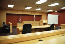 Horrifying Baby-Death Plea Stuns Missouri Interior view of an empty courtroom with wooden furniture and American flags