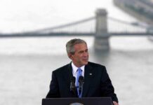 Bush’s Bold Line: Islam Isn’t The Enemy George W. Bush speaking at a podium with a bridge over water in the background
