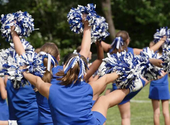 shutterstock_9995908-3 cheerleaders performing with blue and white pom-poms
