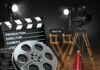 Movie set with film reels and clapperboard.