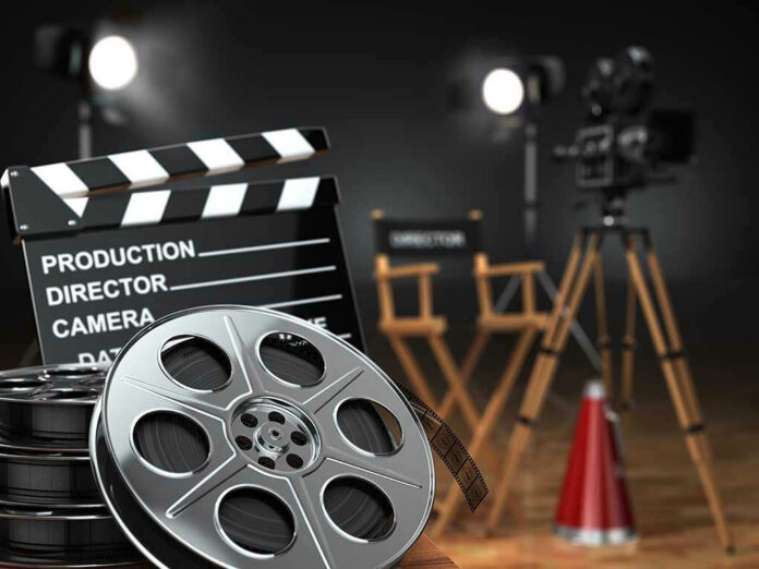 Movie set with film reels and clapperboard.
