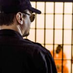 Parole Twist In Amber Guyger Case Security guard watching inmates behind jail bars