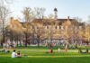 Politics Collides With the Cornell Case Students relaxing on a campus quad in front of a brick academic building