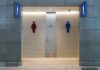 Gender-Neutral Shift Hides a Bigger Pivot Public restroom entrance with male and female symbols